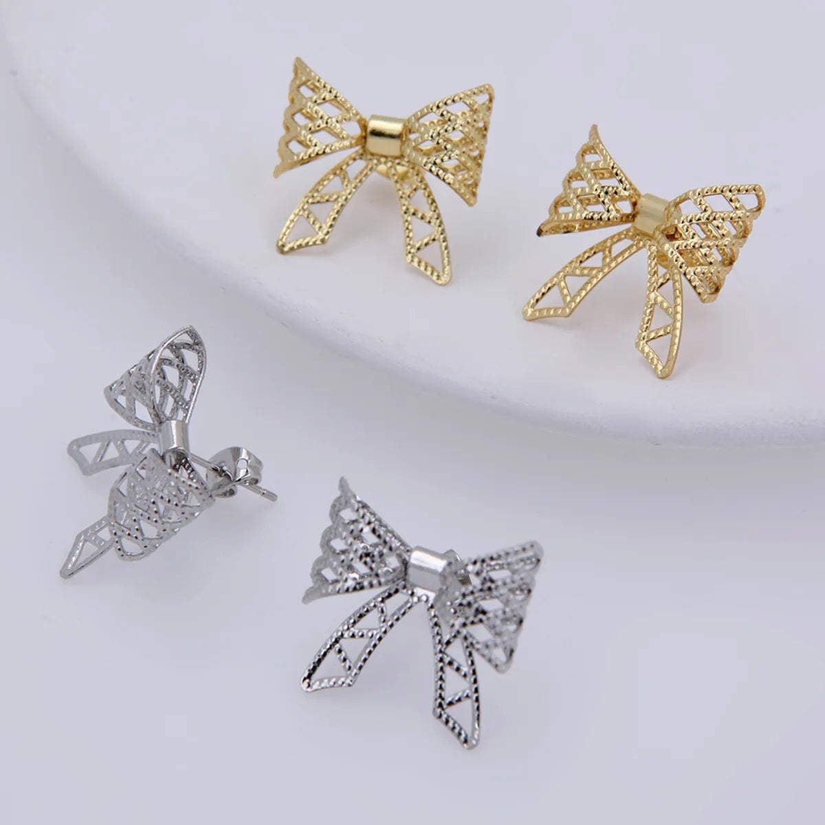 1 Pair Sweet Simple Style Solid Color Bow Knot Plating Hollow Out Copper 18K Gold Plated White Gold Plated Ear Studs