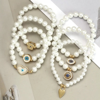 Elegant Devil'S Eye Heart Shape Artificial Pearl Glass Copper Wholesale Bracelets