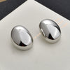 Gold Plated Copper Geometric Oval Sphere Statement Earrings With Glossy Polished Eggshell Design For Women