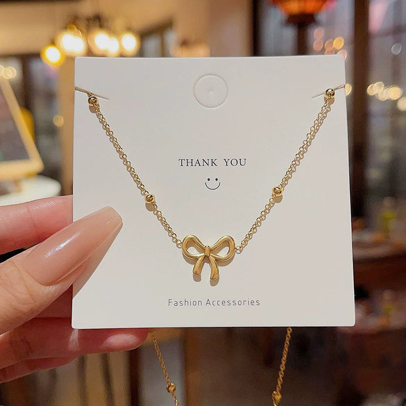 Titanium Steel Gold Inlaid Bow Pendant Necklace Cross Chain Style