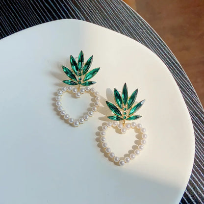 Vacation Modern Style Artistic Fruit Heart Shape Pineapple Alloy Beaded Hollow Out Inlay Artificial Crystal Artificial Pearls Women'S Ear Studs