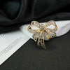 Wholesale Alloy Diamondencrusted Hollow Retro Bow Brooch For Women Electroplated