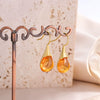 Wholesale Gems Inlaid Drop Shaped Imitation Cat's Eye Stone Fashion Earrings With Electroplating