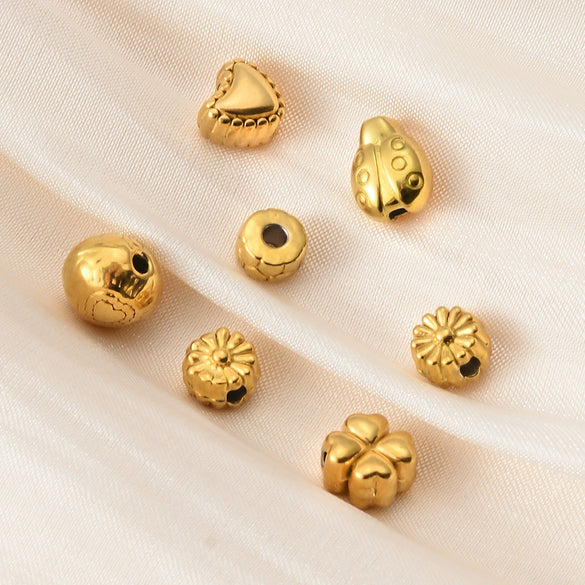 Wholesale Jewelry Titanium Steel Loose Beads Spacer Beads Love Embossed Perforated Fashion Style Drum Beads With Gold Plating