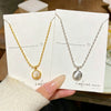 Wholesale Light Luxury Geometric Titanium Steel Cat's Eye Stone Round Pendant Necklace With Rice Chain For Women Real Gold Plated