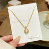 Wholesale Light Luxury Geometric Titanium Steel Cat's Eye Stone Round Pendant Necklace With Rice Chain For Women Real Gold Plated