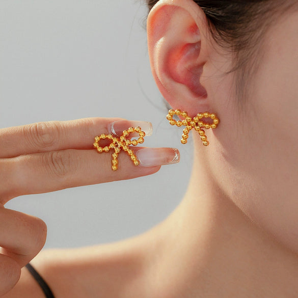 Wholesale Niche Design Round Ball Stitching Bow Style Titanium Steel Earrings Plated With 18K Gold For Women