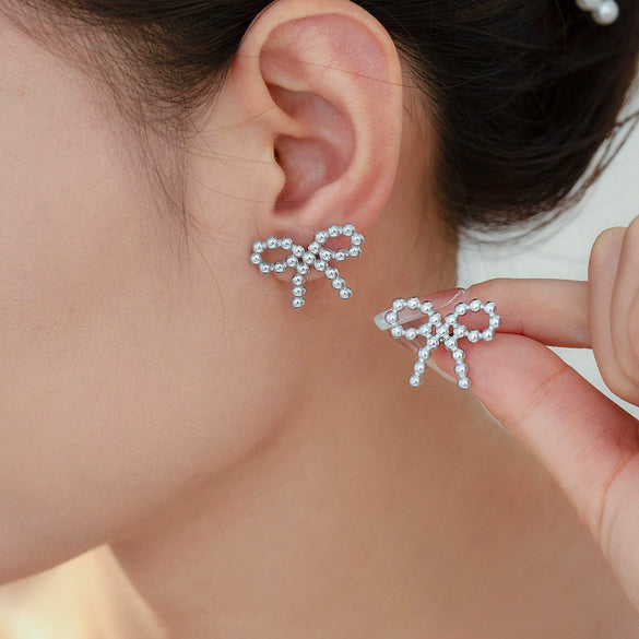 Wholesale Niche Design Round Ball Stitching Bow Style Titanium Steel Earrings Plated With 18K Gold For Women