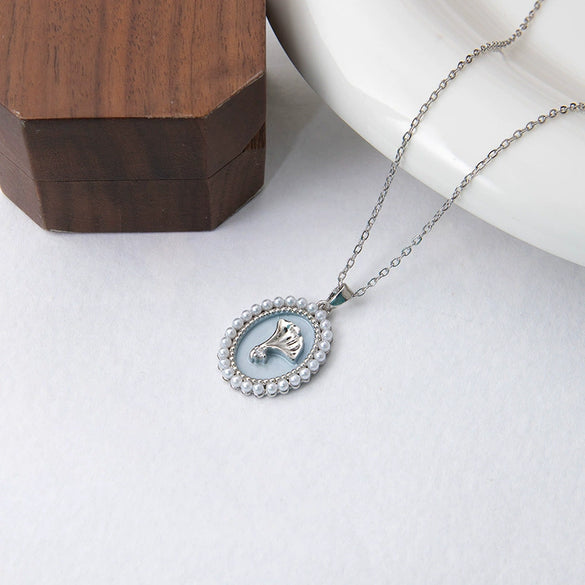 Wholesale Titanium Steel And Copper Ginkgo Biloba And Oval Inlaid Pearl Pendant Necklace For Women With Electroplating Design