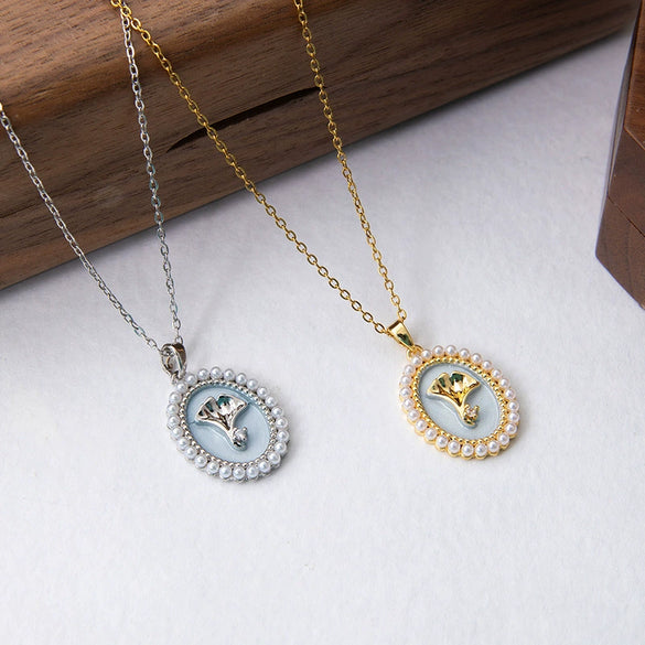 Wholesale Titanium Steel And Copper Ginkgo Biloba And Oval Inlaid Pearl Pendant Necklace For Women With Electroplating Design