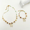 Wholesale Titanium Steel Irregular Hollow Flower Handmade Beaded Necklace And Bracelet Set With Electroplating For Women