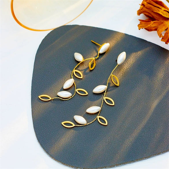 Wholesale Titanium Steel Pearl Hollow Leaf Long Hanging Earrings For Women With Electroplating Design