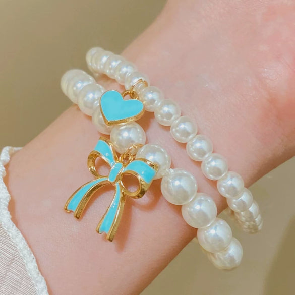 Wholesale Women's Alloy Beaded Bracelet With Irregular Imitation Pearl Stitching And Bow Tie Pendant Electroplating Design