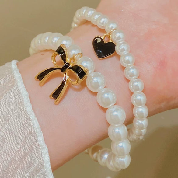 Wholesale Women's Alloy Beaded Bracelet With Irregular Imitation Pearl Stitching And Bow Tie Pendant Electroplating Design