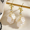 Wholesale Women's Alloy Electroplated Shell Pattern Starfish Petal Earrings With Zircon And Diamonds