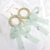 Wholesale Women's Bohemian Style Silk Straw Earrings With Doll Pattern And Ribbon Tassel