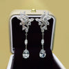 Wholesale Women's Copper Dropshaped Flower Inlaid Zircon Earrings