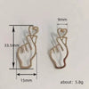 Wholesale Women's Fashion Geometric Copper Hollowout Heart Earrings With Electroplating