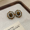 Wholesale Women's Maillard Style Alloy Geometric Tiger Eye Earrings With Electroplating