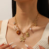 Wholesale Women's Medieval Style Stainless Steel Necklace With Gold Plated Flower Leopard Print Heart And Square Hollow Pendant And Flash O Chain