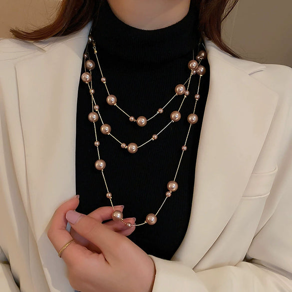 Wholesale Women's Metal And Imitation Pearl Sweater Chain Necklace With Flower Pattern And Light Luxury Style Set With Pearls