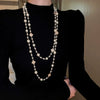 Wholesale Women's Metal And Imitation Pearl Sweater Chain Necklace With Flower Pattern And Light Luxury Style Set With Pearls