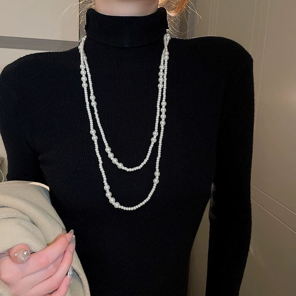 Wholesale Women's Metal And Imitation Pearl Sweater Chain Necklace With Flower Pattern And Light Luxury Style Set With Pearls