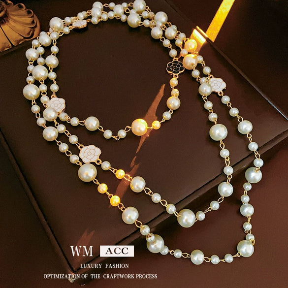 Wholesale Women's Metal And Imitation Pearl Sweater Chain Necklace With Flower Pattern And Light Luxury Style Set With Pearls