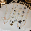 Wholesale Women's Metal And Imitation Pearl Sweater Chain Necklace With Flower Pattern And Light Luxury Style Set With Pearls