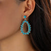 Wholesale Women's Retro Cartoon Drop Shape Hollow Inlaid Turquoise Alloy Earrings