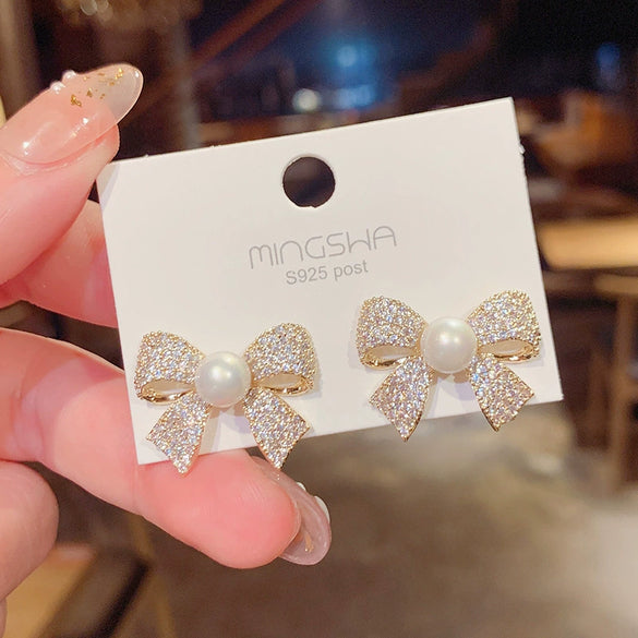 Wholesale Women's S925 Silver Needle Bow Stud Earrings With Micro Inlaid Pearl And Electroplated Alloy Material