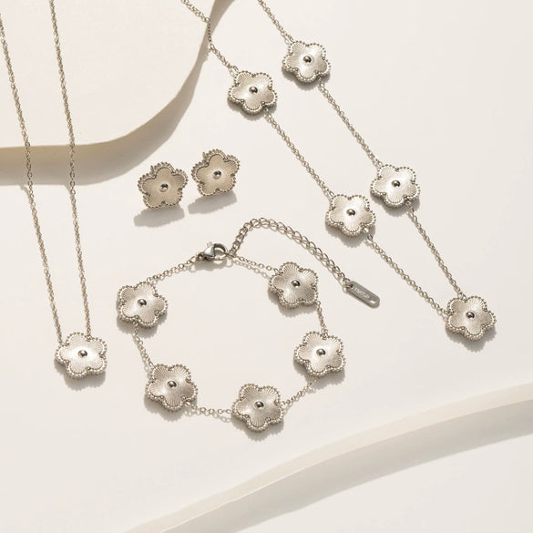 Wholesale Women's Titanium Steel Flower Jewelry Suit With Clover And Plum Blossom Laser Design Electroplated