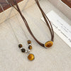 Wholesale Women's Vintage Leather Alloy Clavicle Chain Necklace With Artificial Tiger Eye Stone And Geometric Pattern Electroplated