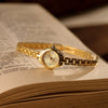 Women's Casual Mini Round Alloy Case And Strap Quartz Watch With Printed Logo