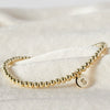 Women's Minimalist Copper Bead Bracelet With Gold Electroplated Letter Charms Round Disc Pendant And Elastic Beaded String