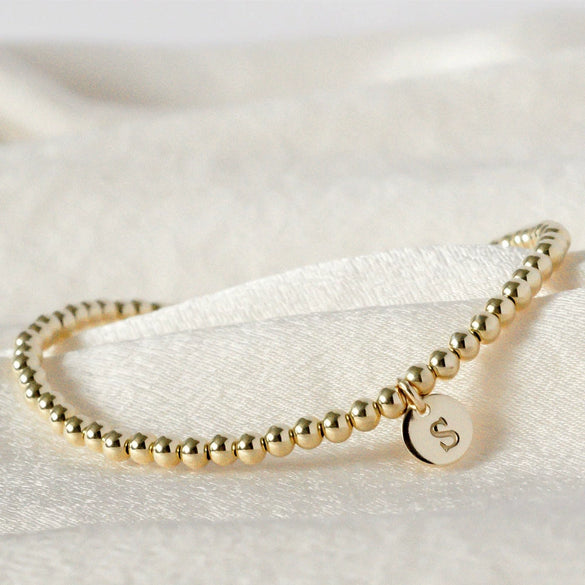 Women's Minimalist Copper Bead Bracelet With Gold Electroplated Letter Charms Round Disc Pendant And Elastic Beaded String