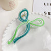 Women's Plastic And Resin Bow Grip Hair Clip With Dripping Oil Design