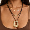 Women's Plated Alloy Geometric Hollow Square Pendant Necklace With Retro Brown Waxed Rope And Beaded Layered Design
